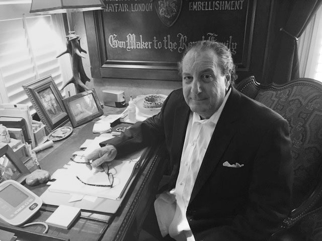 Man sitting at desk with papers.